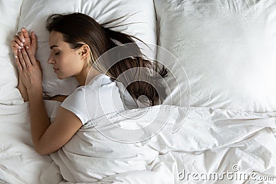 Top view peaceful young woman sleeping on side in bed Stock Photo