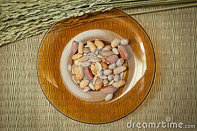Top view,Peanut in plate on the bamboo mats background Stock Photo
