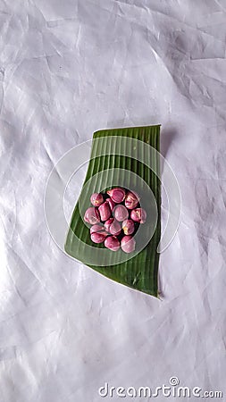 Top view peeled garlic and onion on banana leaf isolated white Stock Photo