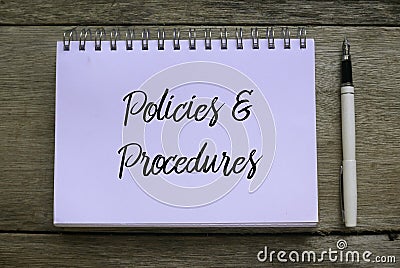 Top view of pen and notebook written with Policies and Procedures on wooden background Stock Photo