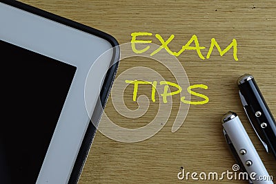 Top view of pen on wooden background written with EXAM TIPS Stock Photo