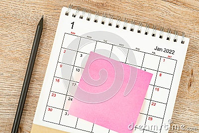Top view of pencil, calendar planning and deadline with sticky note on wooden background, Calendar desk 2022 on January month Stock Photo