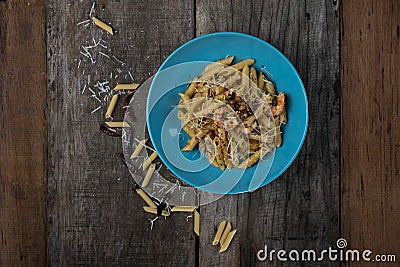 Top view of penne with garlic and oil aglio e olio. Spicy pasta with prawns and cheese Stock Photo