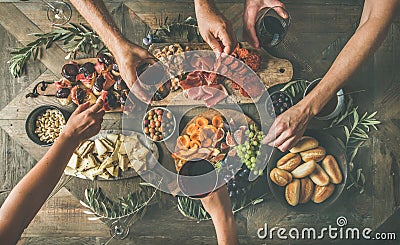 Top view of people drinking, eating together and holding glasses Stock Photo