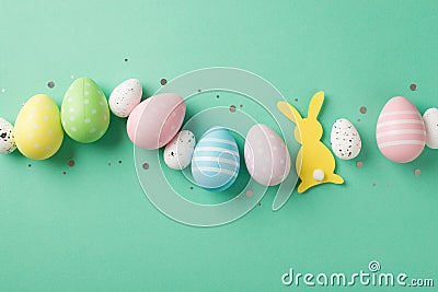 Top view photo of easter decorations shiny confetti row of multicolored easter eggs and easter bunny silhouette on isolated Stock Photo