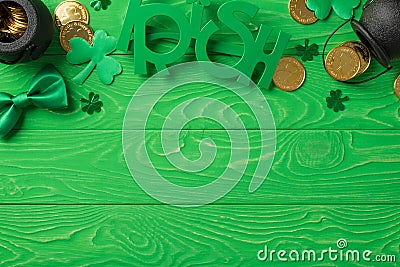 Top view photo of the Irish glasses with hats black two pots with many coins inside and around soft confetti in shape of clovers Stock Photo