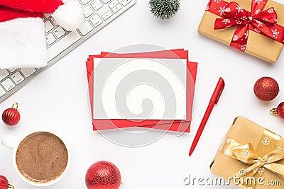 Top view photo of keyboard cup of hot drinking santa claus hat pine toy red christmas tree balls gift boxes stack of red envelopes Stock Photo