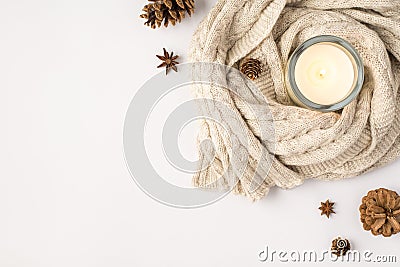 Top view photo of lighted candle in candlestick sweater pine cones and anise on isolated white background with blank space Stock Photo