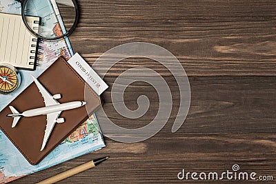 Top view photo of map magnifier compass notebook pen and airplane model on leather passport cover with covid test on isolated Stock Photo