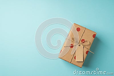 Top view photo of saint valentine`s day decorations kraft paper giftbox with polka dot pattern pricetag and twine bow on isolated Stock Photo