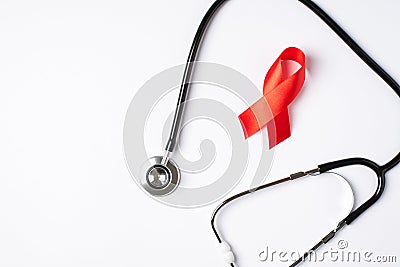 Top view photo of stethoscope and red silk ribbon symbol of aids awareness on isolated white background with copyspace Stock Photo