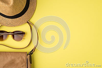 Top view photo of sunhat sunglasses and leather bag on isolated yellow background with copyspace Stock Photo