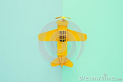 top view photo of toy airplanover double colorful background. Concept of imagination, creativity, dreaming and childhood. Stock Photo