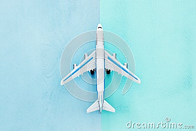 top view photo of toy airplanover double colorful background. Concept of imagination, creativity, dreaming and childhood. Stock Photo