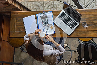 Top view photo of freelancer drinking hot cup of Cappuccino Stock Photo