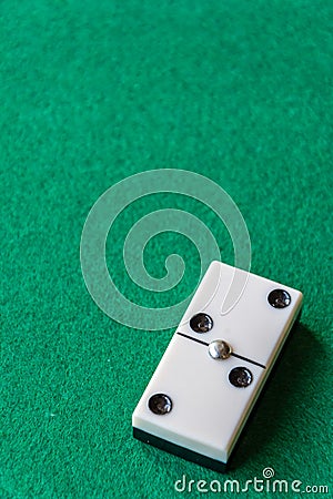 Top view of a piece of dominoes, with the number two double on green mat to play, vertically Stock Photo