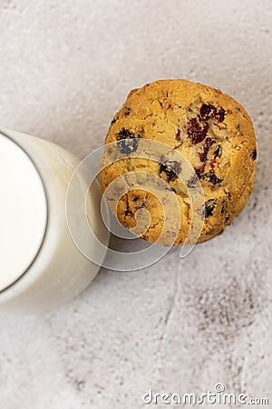 Top view of a pile of chocolate chip cookie beside a glass of milk on a table Stock Photo