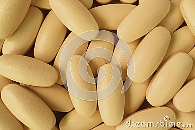 Top view of pile of creamy yellow oval shaped pills for background or banner Stock Photo