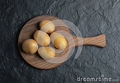 Top view of pile of potatoes on wooden cutting board Stock Photo
