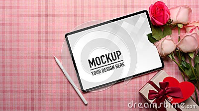 Top view of pink Scott table with digital tablet, pink flower and gift box Stock Photo