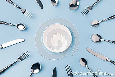 top view of plate surrounded by flatware Stock Photo