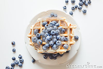 Plate of tasty stacked waffles with blueberries Stock Photo