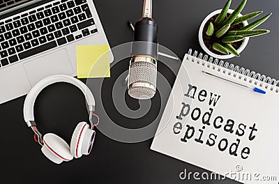 Top view of podcast recording equipment on desk with words new podcast episode written on note pad Stock Photo