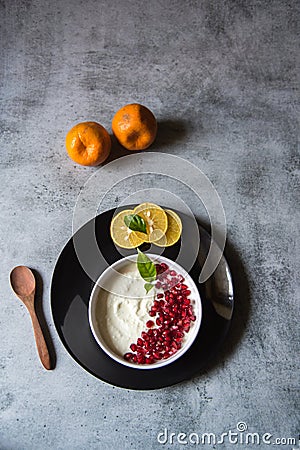 Top view of pomegranate seeds on curd along with fresh fruit ingredients Stock Photo