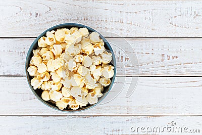 Top view popcorn in blue bowl on white wooden table Stock Photo