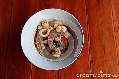 Top view Pork noodles, a popular local Asian food in Thailand, noodles with a wide variety of vegetables on the dining table. Stock Photo