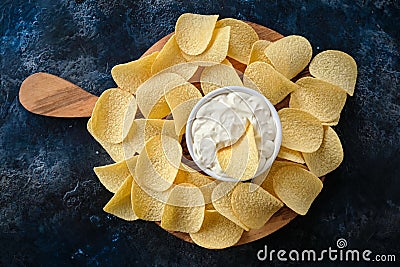 Top view potato chips, sauce in a white bowl on a wooden cutting board Stock Photo
