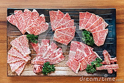 Top view of Premium Rare Slices many parts of Wagyu A5 beef with high-marbled texture on stone plate served for Yakiniku. Stock Photo
