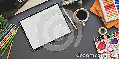 Top view of professional artist workplace with blank screen tablet and painting tools Stock Photo