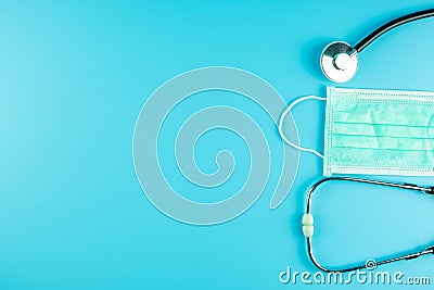 Top view Protective face mask and Stethoscope on blue background with copy space for text. Protection of Coronavirus , Covid-19 Stock Photo