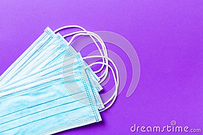 Top view of protective medical masks on purple background. Ncov and covid epidemic. Pandemic concept. Protect your health with Stock Photo