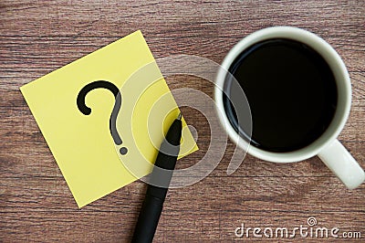 Top view of question mark on notepad with pen on coffee. Question and answer concept Stock Photo