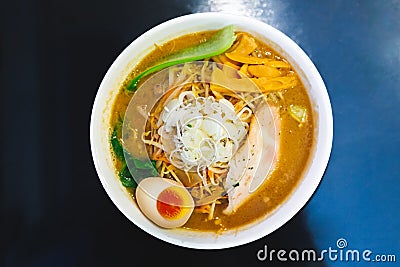 Top view of Ramen Pork Bone Soup Tonkotsu Ramen with Chashu Pork, Scallion, Sprout, Carrot, Menma Seasoned Bamboo Shoots. Stock Photo