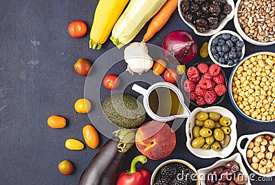 Top view of raw Mediterranean diet ingredients placed on dark background. Editorial Stock Photo