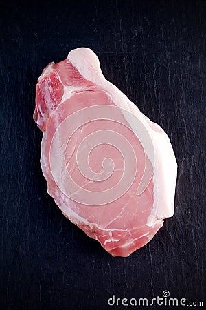 Top view raw pork loin steak on stone background Stock Photo