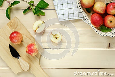 Top view red apple napkin,knife,basket on wooden. Stock Photo