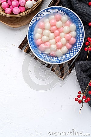 Top view of red and white tangyuan in blue bowl on white background for Winter solstice Stock Photo