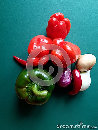 Top view of rich selection of fresh organic vegetables on a green background Stock Photo