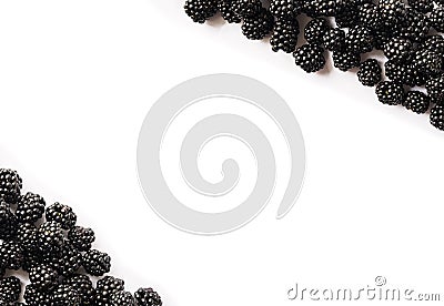 Top view. Ripe blackberries on white background. Berries at border of image with copy space for text. Stock Photo
