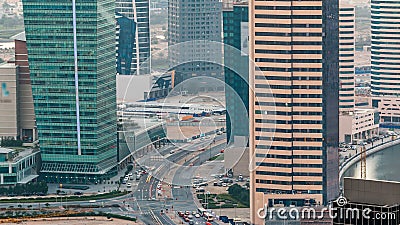 Top view of road in Dubai downtown timelapse with day traffic and business bay skyscrapers. Editorial Stock Photo