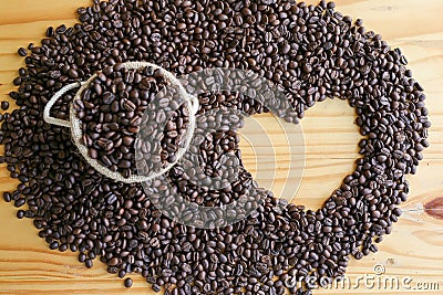 Top view of roasted coffee beans with heart shape space on wooden table Stock Photo
