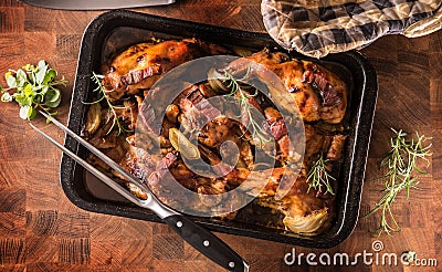 Top of view roasted rabbit with onion garlic bacon and herbs Stock Photo