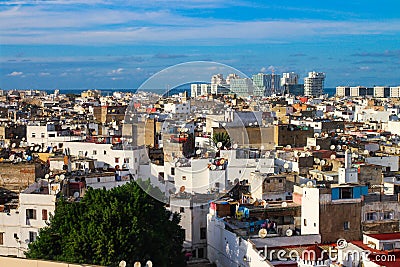 Top view of the rooftops of Casablanca with lots of satellite dishes and drying clothes. In the distance high-rise buildings, Editorial Stock Photo