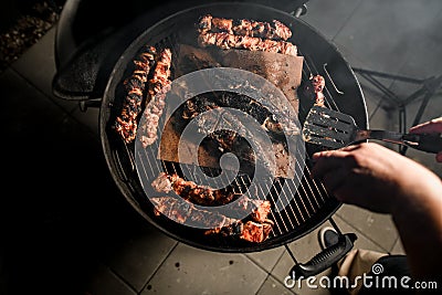 Top view on grill with pieces of fried meat and fish in center Stock Photo