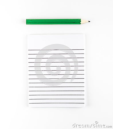 Top view of Ruled paper notepad with green pencil on white background Leave space for adding your content Stock Photo