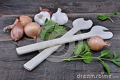 rustic arrangement with culinary condiment and wooden spoon on a plank Stock Photo